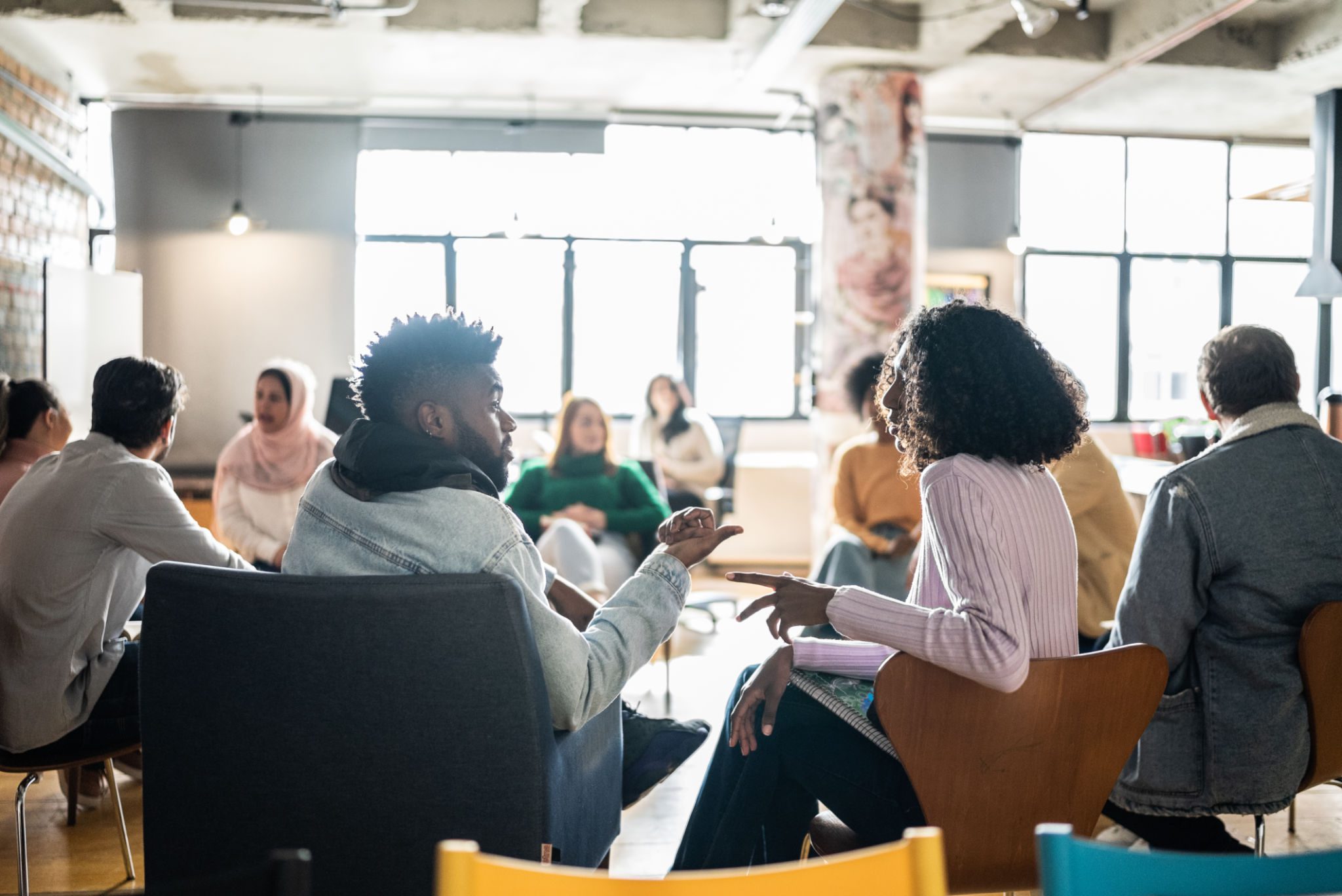 A diverse group collaborating in a casual office meeting.